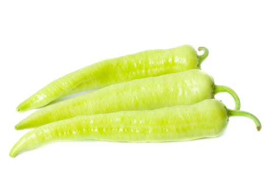 Three long green peppers isolated on white background