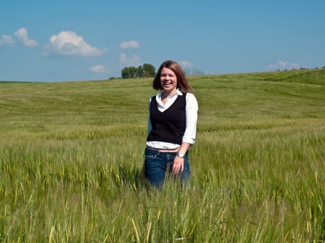 Beautiful attractive smiling young happy woman girl in a wheat field