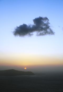 An heart-shaped cloud during a beautiful sunset in Santorini