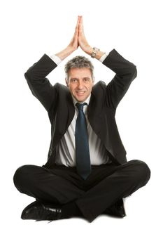 Businessman sitting in lotus flower position of yoga. Isolated on white