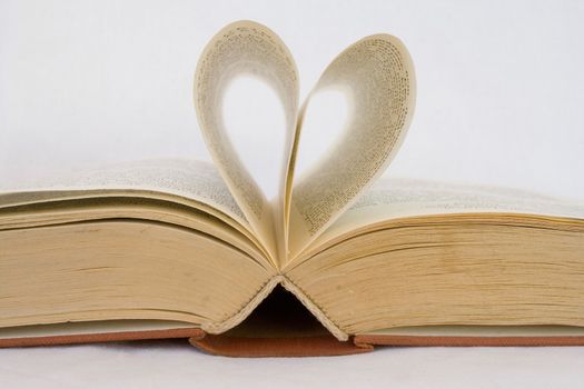 Pages of a book curved into heart shapes