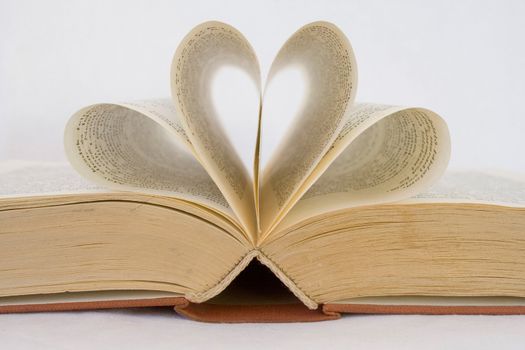 Pages of a book curved into heart shapes