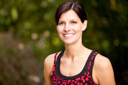 A happy fitness woman in the park - lifestyle portrait