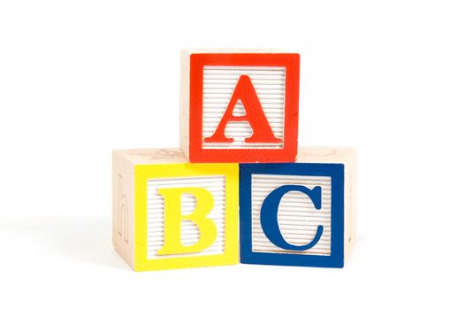 ABC wooden blocks stacked vertically isolated on white
