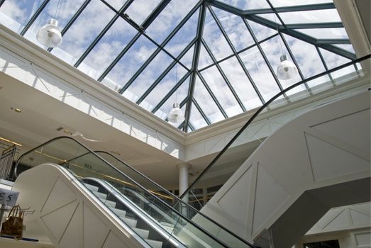 Escalator in a mall with glass roof
