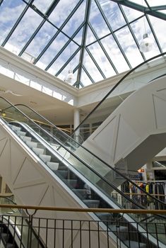 Escalator in a mall with glass roof