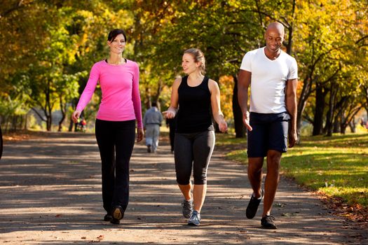 Three people walking in a park, getting some exercise