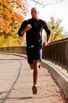 An African American jogging in a park in the morning