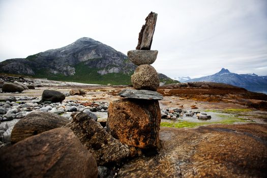 A rock stacking sculpture statue on a Norwegian landscape