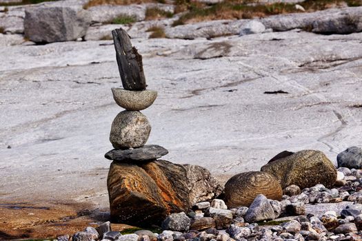 A rock stacking sculpture statue on a Norwegian landscape