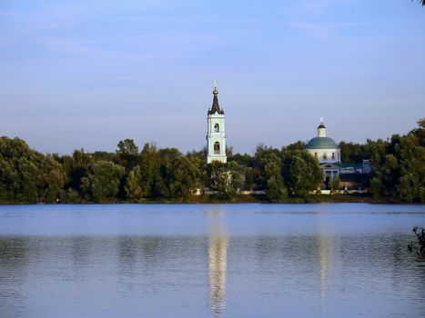 Landscape with Russian orthodox church reflecting in water