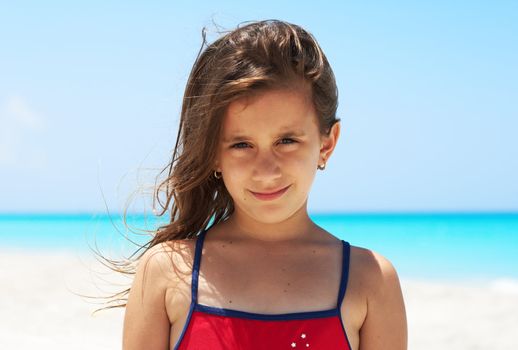 Portrait of a beautiful caucasian girl smiling in the beach