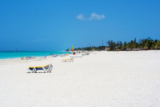 View of a sandy beach with people enjoying summer