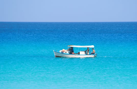 View of a small fishing boat in a calm blue sea