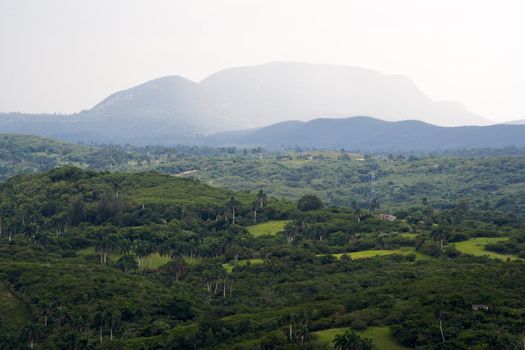 Tropical valley with high mountains in the background