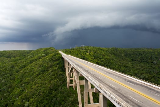 Tall bridge in a stormy weather with interesting clouds in the sky