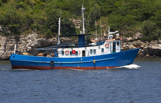 Fishing boat in a rocky bay