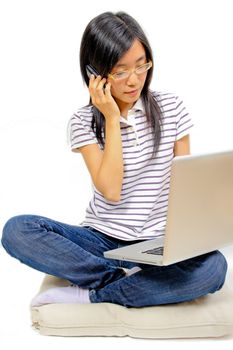 Young chinese woman sitting on the floor with laptop
