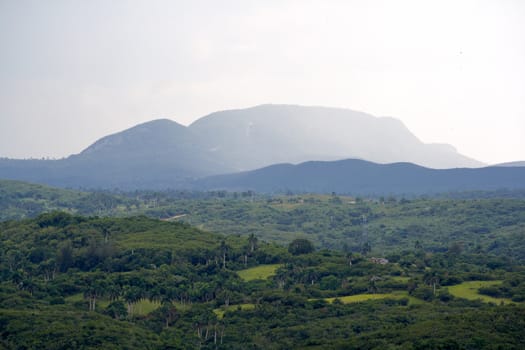 Tropical valley with high mountains in the background