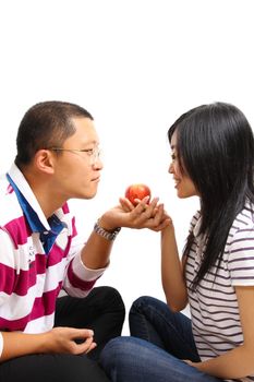 Young chinese couple sharing an apple