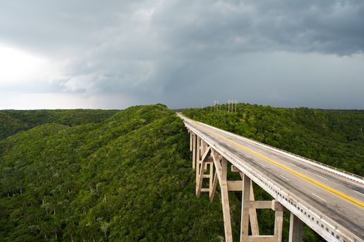 Tall bridge in a stormy weather with interesting clouds in the sky