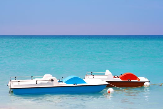 A couple of pedal boats in a lovely tropical beach