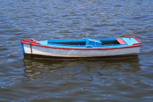 Old fishing boats with reflections in the sea