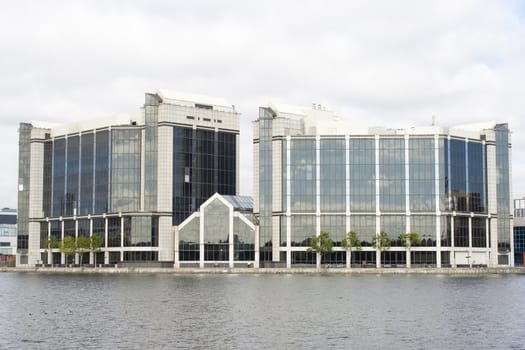 Modern steel and glass building by the riverside