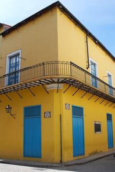 Old house in a corner painted with bright colors in Havana