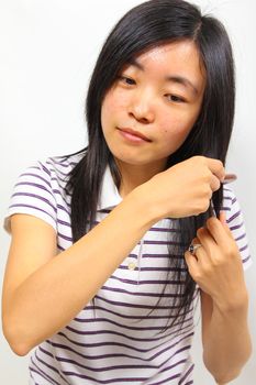 Young chinese woman brushing her hair