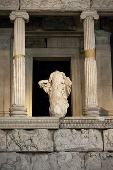 Ruins of a greek temple with a statue and columns