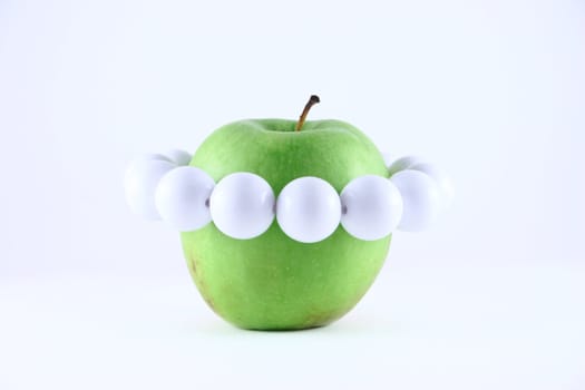 Green apple with a white beads removed on a white background close up