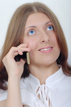 Portrait of the nice girl talking by a mobile phone