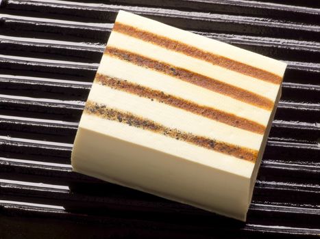 close up of a slab of tofu on a grill