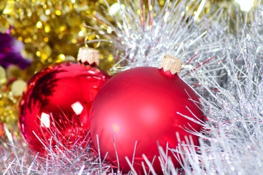 Two glass New Year's balls in a tinsel removed close up