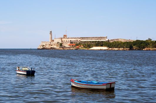 The bay of Havana with fishing boats and El Morro fortress