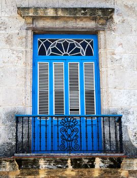 Old typical colonial balcony painted in vivid blue