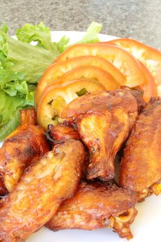 Chicken Wings on a White Plate with Vegetables