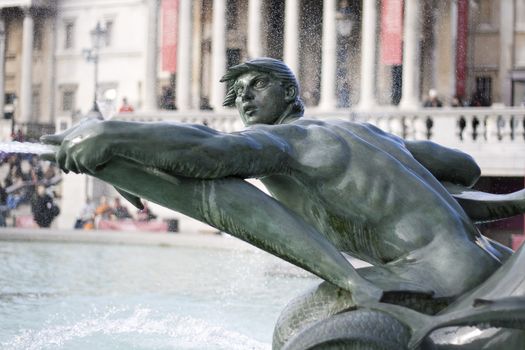 Fountain in Trafalgar Square in London representing a man and dolphins