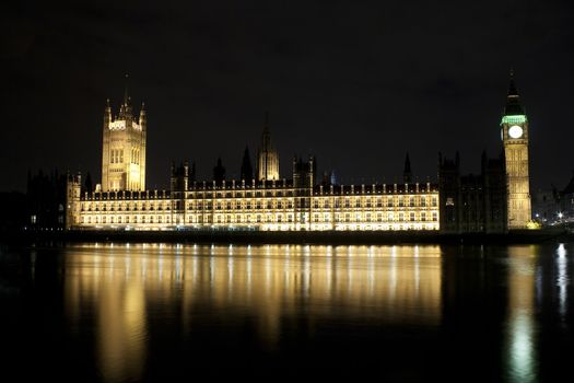 The Big Ben and the Parliament illuminated at night with reflections in the river
