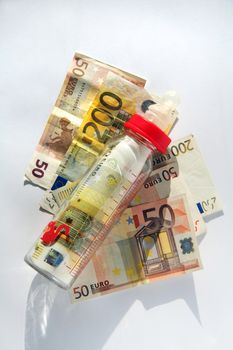 Babys bottle with many bills of euro