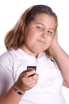 A young girl listening to her MP3 player isolated against a white background