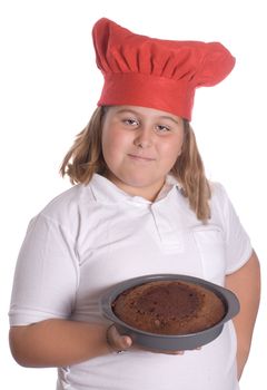 A young girl holding up a brown cake that she baked, isolated against a white background