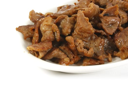 Stir Fried Pork Stips on a White Surface