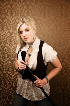 Pretty young singer or comedian with microphone and stand