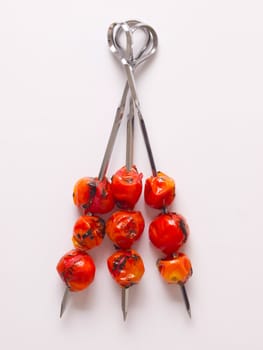 close up of roasted cherry tomato skewers