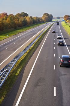 Part of a european highway with cars in motion.