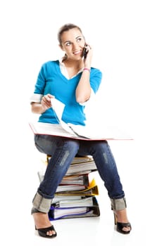 Beautiful female student making a phone call isolated on white