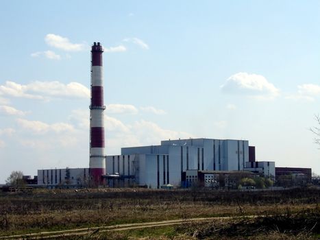 Waste recycling industrial plant on a background of blue sky with clouds