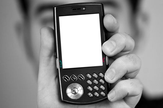A man holding up a cellular phone.  Clipping path included for the white space on the lcd screen.